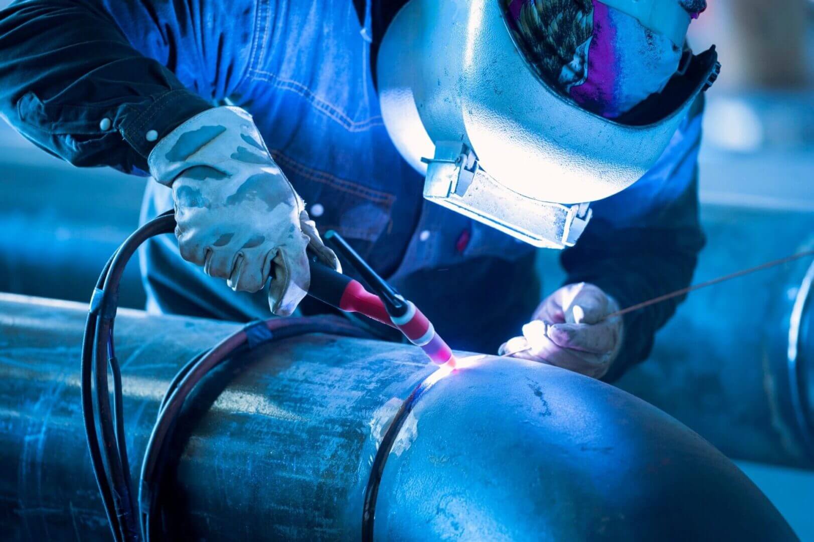 Midwest Mechanical Systems pipe fitter welding large diameter industrial piping on a construction project